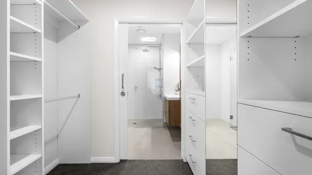 Ōtākaro Apt - walk in wardrobe and bathroom 