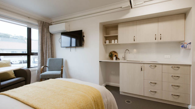 Crofton Downs Care Home room bed and kitchenette