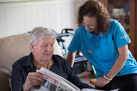 Care home reading newspaper