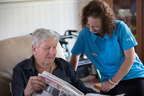 Care home reading newspaper