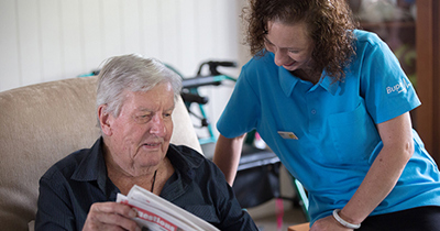 Care home reading newspaper