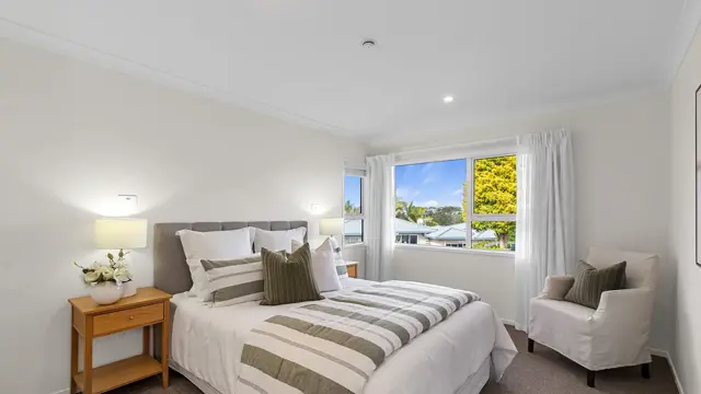 Remuera _ Villa 21 _ bedroom with chair