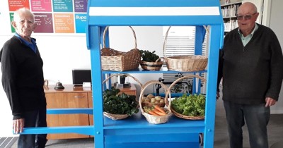residents with cart of veges