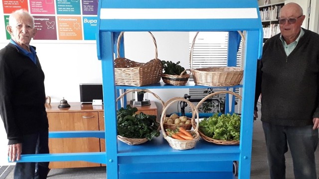 residents with cart of veges