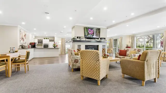 Cashmere View _ Community centre, fireplace with TV above and chairs 