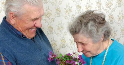 Retired couple Giving Flowers